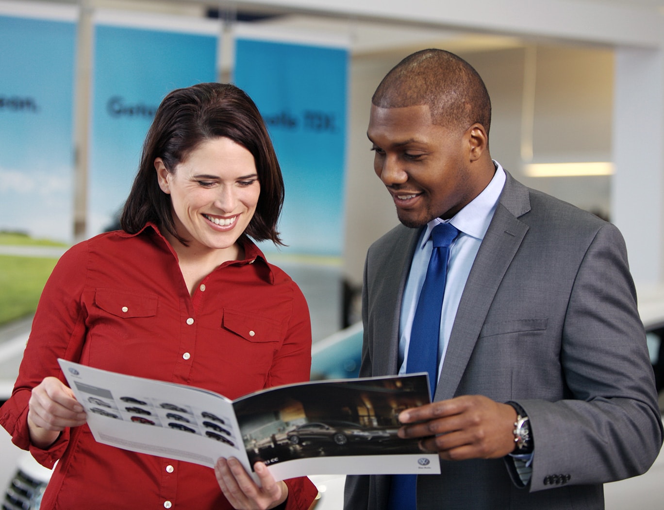 Person cheerfully signing documents.